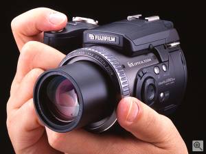 Fuji's FinePix 6900Z digital camera, shown in hand  for scale. Courtesy of Fuji. Click for a bigger picture!