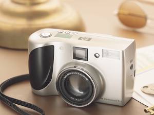 Hewlett Packard's PhotoSmart 715 digital camera. Courtesy of Hewlett Packard, with modifications by Michael R. Tomkins. Click for a bigger picture!