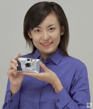 A model holds Casio's QV2100 digital camera to demonstrate the size. Courtesy of Casio Computer Co. Ltd. Click for a bigger picture!