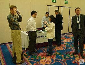 Fuji's Andy Laguardia talks to an attendee as our own Dave Etchells examines the new FinePix 2800 Zoom digital camera. Copyright © 2001, Michael R. Tomkins. All rights reserved. Click for a bigger picture!