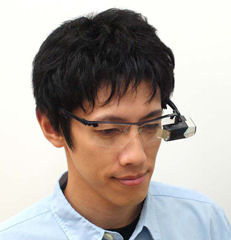 Mobile spectacle-type wearable retinal imaging display shown in use. Photo provided by Brother Industries Ltd.