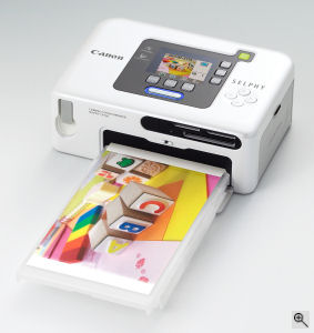 Canon's SELPHY CP730 digital camera. Courtesy of Canon, with modifications by Michael R. Tomkins. Click for a bigger picture!