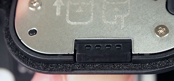 Canon EOS R Review -- close-up of battery compartment door showing latch slider and gasket.