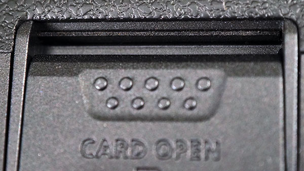 Canon EOS R Review -- extreme close-up of memory card compartment door hinge.