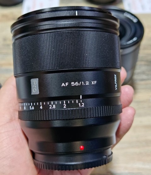 A person holding the Viltrox 56mm f/1.2 Pro